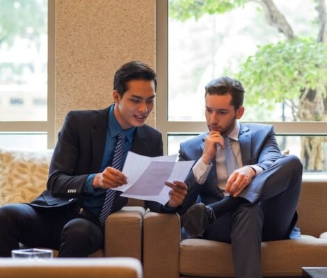 two-business-men-discussing-document-lounge_1262-3332 two-business-men-discussing-document-lounge_1262-3332